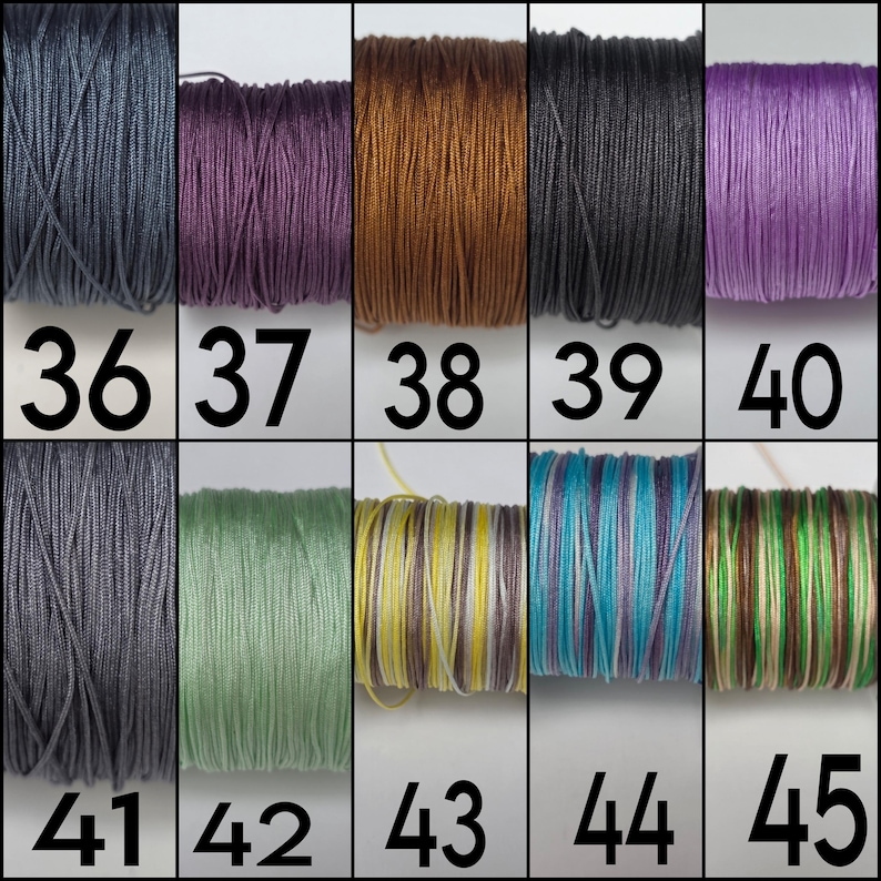 May include: A grid of ten spools of thread labeled 36 through 45. The colors include dark gray, deep purple, copper, black, light purple, medium gray, sage green, yellow and white stripes, blue and purple stripes, and green and brown stripes.