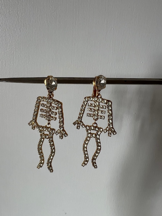 Articulated skeleton drop earrings, gold metal an… - image 1