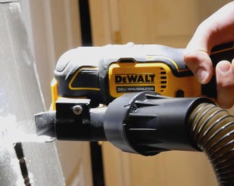 May include: A yellow and black DeWalt 20V Brushless oscillating multi-tool with a black dust extraction attachment connected to a flexible hose, positioned against a flat metallic surface while in operation.