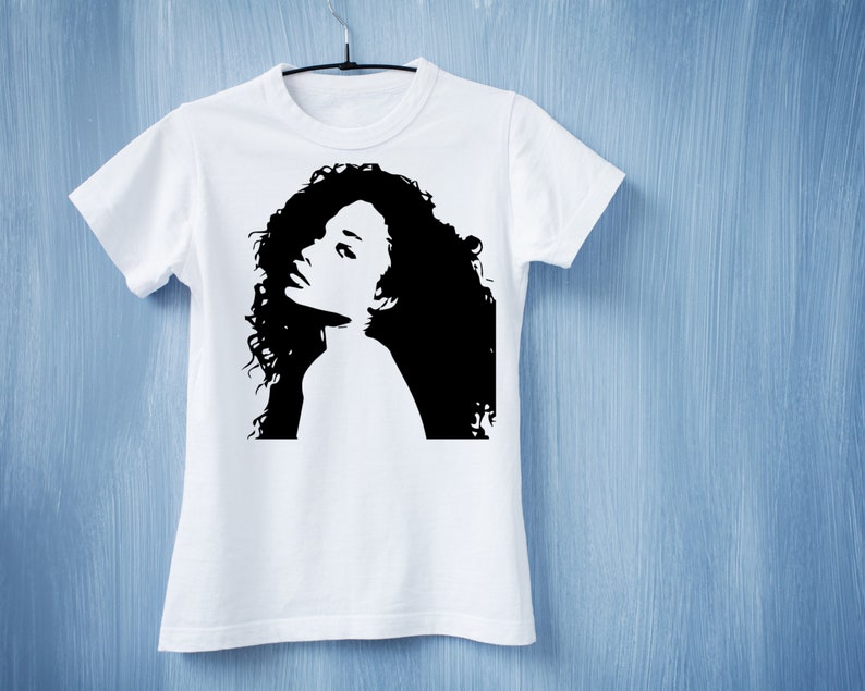 May include: White t-shirt with a black silhouette of a woman with curly hair.