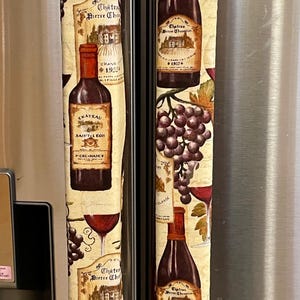 May include: A white ceramic mug with a wraparound design featuring a vibrant, colorful illustration of a toucan bird perched on a branch. The mug has a black handle and a glossy finish.