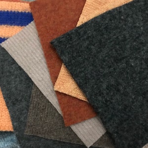 May include: A collection of fabric swatches in various colors and textures, including orange, brown, gray, and blue. The swatches are arranged in a random pattern.