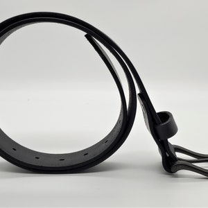May include: A black leather belt with a matte finish. The belt is looped, showcasing the buckle and the series of holes for adjustment. The buckle is a simple, rectangular design. The belt is a classic accessory.