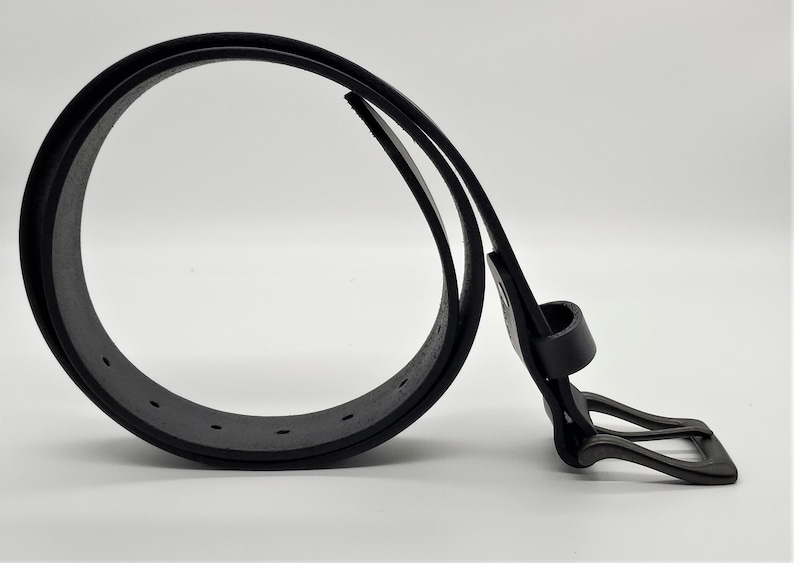 May include: A black leather belt with a matte finish. The belt is looped, showcasing the buckle and the series of holes for adjustment. The buckle is a simple, rectangular design. The belt is a classic accessory.