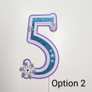 May include: Purple, white, and blue layered paper number five with glitter and snowflake embellishments. Option 2.