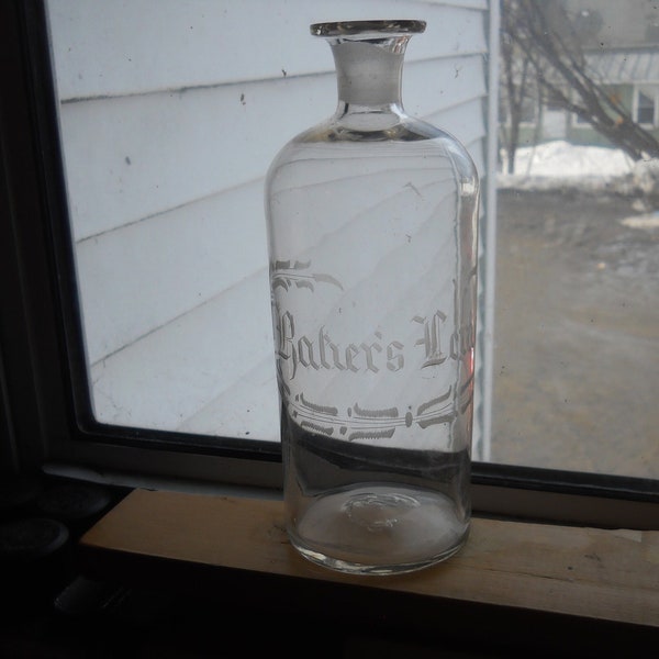 Old bottle, 1850 to 1860 pontiled clear glass Baker's  Lemon on front , collectible pontiled glass bottle