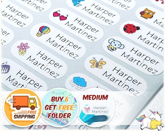 May include: White oval-shaped name labels with various colorful illustrations, including a butterfly, a ladybug, a hot air balloon, a flower, a cloud, a dolphin, a heart, an owl, a monkey, and a unicorn. The labels read "Harper Martinez" in black text. The image also includes a red truck with the text "Free Shipping" and a green circle with the text "Buy 6 Get Free Folder".