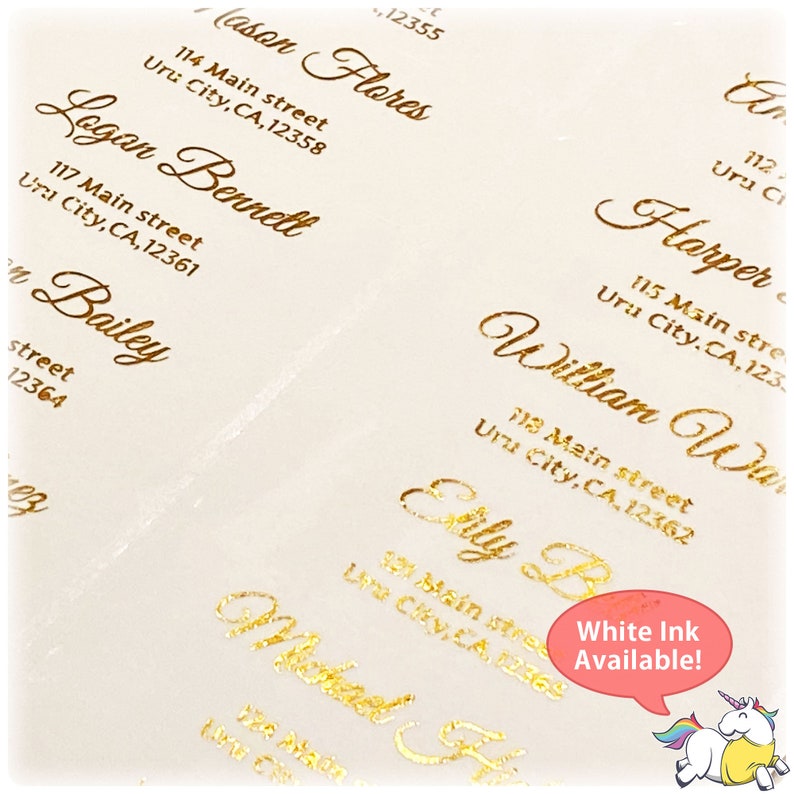 May include: Gold foil address labels with names and addresses printed on white paper. The text includes names like Cason Flores, Logan Bennett, Bailey, Harper, William Walker, and Etty B. The text also includes street addresses and city, state, and zip codes. The text "White Ink Available!" is written in a speech bubble with a unicorn illustration.
