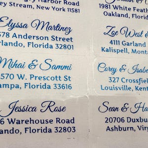 May include: A set of 10 address labels with blue cursive names and addresses printed on white paper.