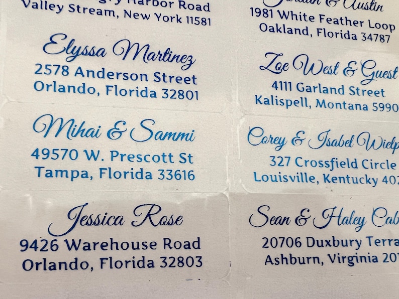 May include: A set of 10 address labels with blue cursive names and addresses printed on white paper.