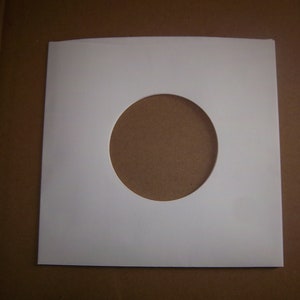 May include: White paper record sleeve with a round hole in the center.