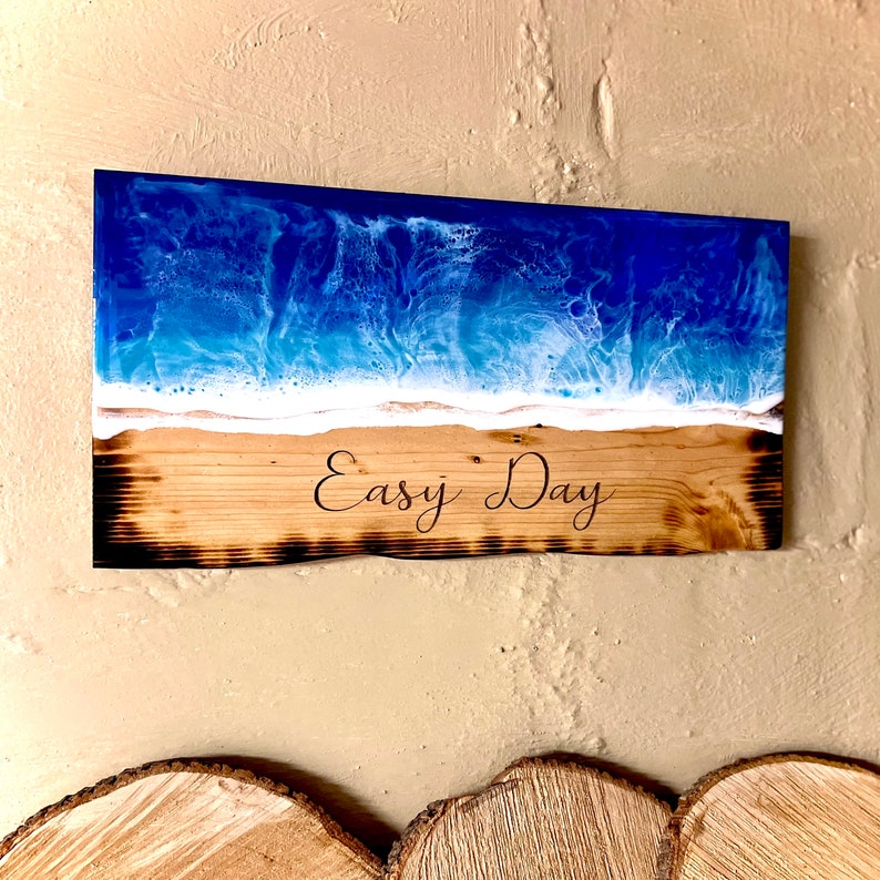 May include: A wooden sign with a blue and white resin ocean scene and the text "Easy Day" burned into the wood.