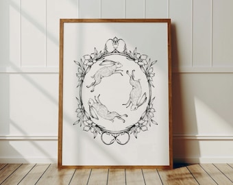 May include: Black and white illustration of four hares hopping in a circle, surrounded by a wreath of flowers. The hares are in a stylised, almost cartoonish style.