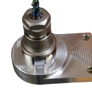 May include: A silver-colored metal milling machine tool with a hexagonal head and a cutting bit. The tool is mounted on a rectangular base with screw holes and a textured surface. The cutting bit has a multi-colored finish.