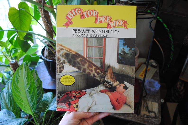 May include: A vintage children's book titled "Big Top Pee-wee: Pee-wee and Friends, A Color and Fun Book" featuring a colorful illustration of a giraffe on the cover.