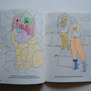 May include: A coloring book page with a lion and a person. The lion is standing on a pedestal with a star on it. The person is standing next to the lion and has a star on their chest. The text on the page says "Here's Oscar the lion tamer and his lion, Sheldon."