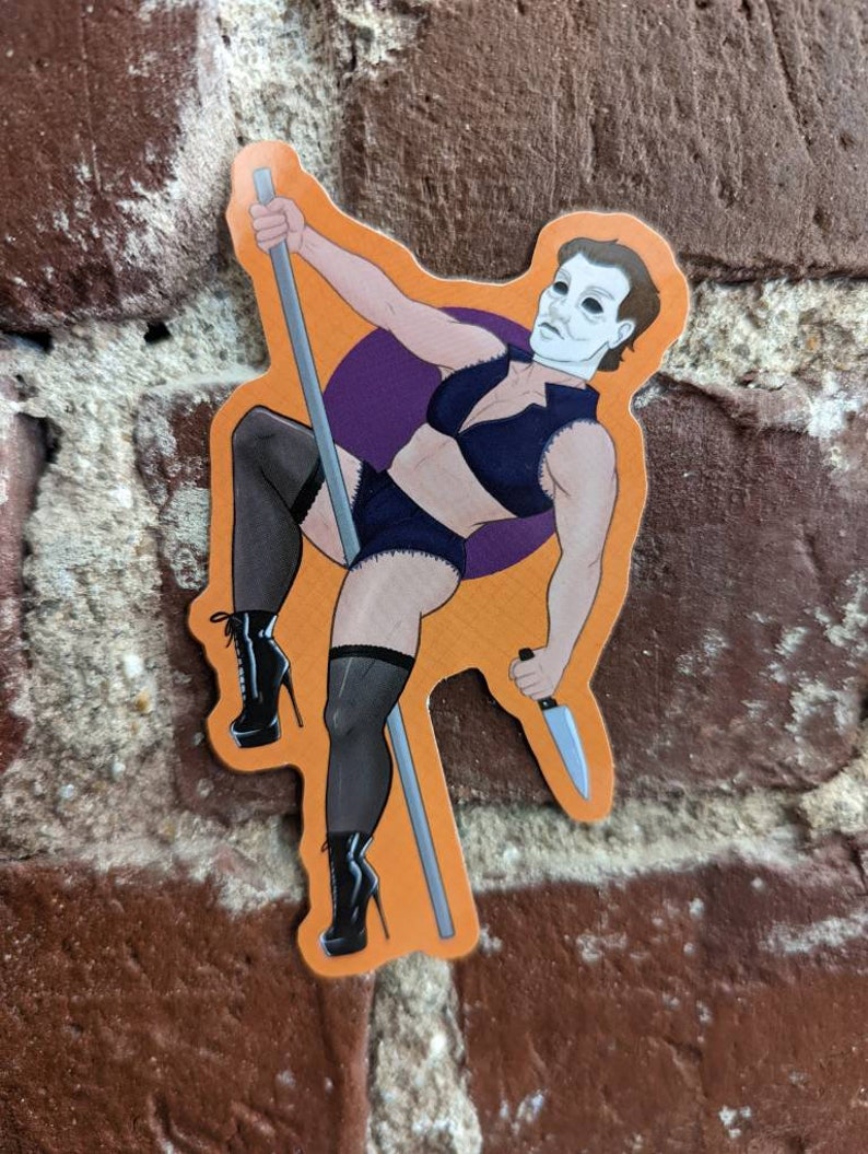 May include: An orange sticker featuring a cartoon illustration of a figure in a black lingerie set, holding a knife and a pole. The figure is wearing black high-heeled boots and a white mask. A purple circle is behind the figure.