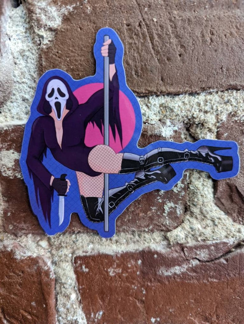 May include: A sticker featuring a cartoon illustration of the Ghostface character from the Scream horror film franchise. The character is depicted in a provocative pose, wearing a black outfit, fishnet stockings, and high-heeled boots, holding a knife and a pole.