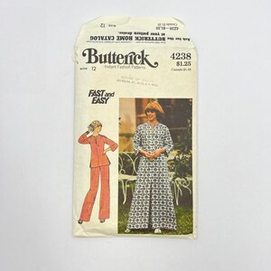 May include: Vintage Butterick sewing pattern envelope, size 12. The envelope features illustrations of a pantsuit and a long dress. The text "FAST and EASY" is printed on the front. The envelope is cream-colored with text and illustrations.