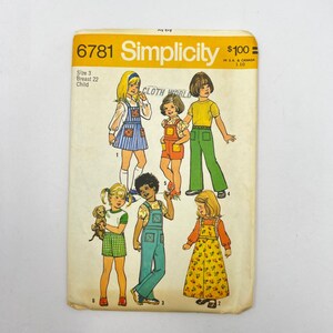 May include: Vintage Simplicity sewing pattern 6781 for children's clothing. The pattern features illustrations of various outfits, including overalls, dresses, and shorts. The package has the text "Simplicity" and "Cloth World".