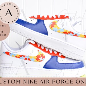May include: Custom Nike Air Force 1 sneakers with a blue and red base and a yellow, blue, and red puzzle piece design on the swoosh.