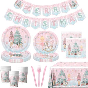 May include: A festive Christmas party set with a pink and blue color scheme. Includes plates, cups, napkins, cutlery, and a tablecloth, all decorated with a nutcracker, Christmas tree, and ballerina theme. A banner spells out "MERRY CHRISTMAS".