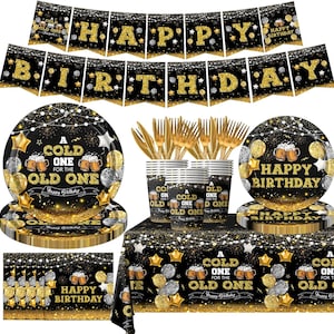 May include: A black and gold birthday party set. Includes a banner that says "HAPPY BIRTHDAY", plates, cups, cutlery, and a tablecloth. The plates and cups have the text "A cold one for the old one" and "Happy Birthday".