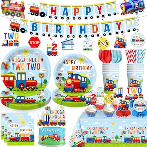 May include: A colorful train-themed birthday party set. Includes plates, cups, napkins, a banner that says "Happy Birthday", and a cake topper. The set features illustrations of trains, railroad crossings, and the number "2".