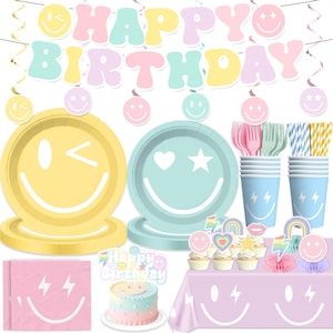 May include: A collection of pastel-colored birthday party supplies. Includes plates, cups, napkins, cutlery, straws, a tablecloth, cupcake toppers, and a banner that says "Happy Birthday". Smiley faces and lightning bolts are featured throughout.