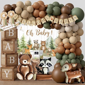 K&ouml;nnte beinhalten: Dekorationsset f&uuml;r eine Babyparty mit Waldthema. Enth&auml;lt einen Ballonbogen in Braun- und Gr&uuml;nt&ouml;nen, Holzbl&ouml;cke mit der Aufschrift "BABY" und Tierfiguren. Ein Banner lautet "WELCOME BABY".