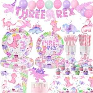 May include: A party supplies set with a dinosaur theme. Includes plates, cups, napkins, cutlery, balloons, and a banner that says "THREE REX". The color scheme is pink, purple, and green.