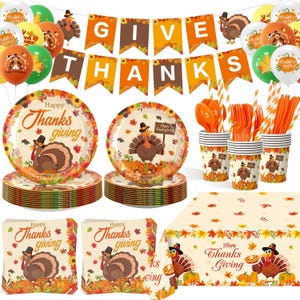 May include: Thanksgiving party supplies set. Includes plates, napkins, cups, cutlery, balloons, and a banner that reads "Give Thanks." The plates and napkins feature a turkey illustration and the words "Happy Thanksgiving."