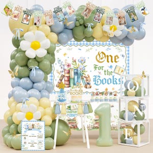 May include: A birthday party decoration set featuring a balloon arch in sage green, dusty blue, and pale yellow with white daisy accents. Includes a backdrop with the text One For the Books, a number one balloon, photo banners, and letter boxes.