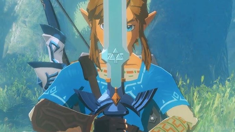 May include: A character from the Legend of Zelda video game series holds the Master Sword. The sword is light blue with a gold and blue hilt. The character wears a blue tunic and has long, light brown hair and pointed ears.