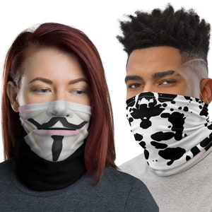 May include: Two people wearing face masks. One mask features a black and white splatter pattern, the other mask features a white face with a black mustache, goatee, and pink lips.