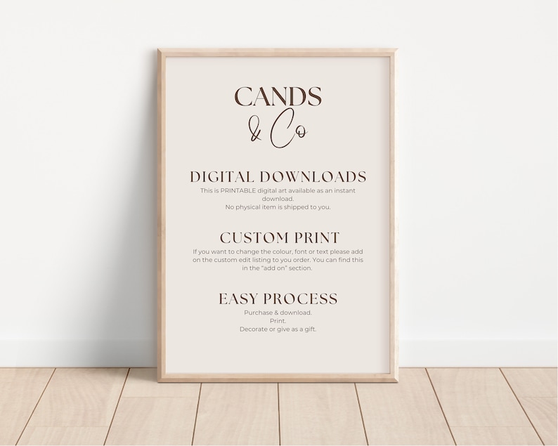 May include: A framed print with the text "CANDS & Co" at the top, followed by details about digital downloads, custom prints, and the easy process of purchasing and printing. The frame is light brown, and the background is a soft beige.