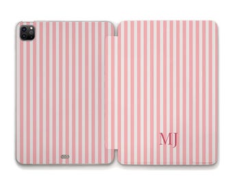 May include: Pink and white striped tablet case, open to reveal the interior. The case features a vertical stripe pattern and the initials "MJ" in the lower right corner. The case is designed to protect a tablet.