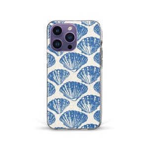 May include: A phone case with a repeating pattern of blue seashell illustrations on a cream background. The case has a clear border and a camera module with multiple lenses.