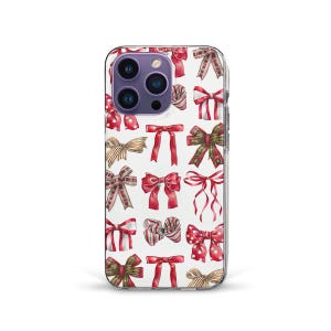 May include: A clear phone case featuring a pattern of various watercolor bows in red, green, gold, and brown on a white background. The bows vary in style and size, creating a festive design.