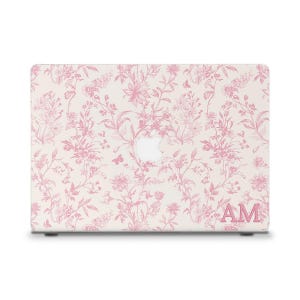 May include: A laptop case featuring a pink floral pattern with a white background. The design includes flowers, leaves, and butterflies. The initials "AM" are displayed in the lower right corner.