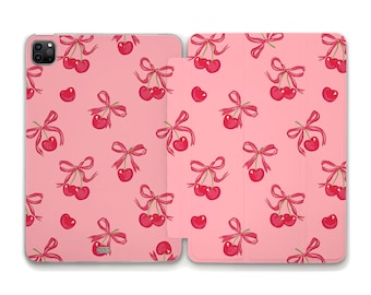 May include: A pink phone case with a pattern of red cherries with bows. The case is designed to fit a phone with a camera bump.