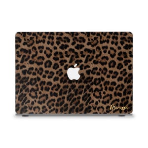 May include: A laptop case with a brown and black leopard print pattern. The Apple logo is white. The name "Marissa" is written in gold script on the lower right corner.