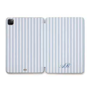 May include: A light blue and white vertical striped tablet case featuring a camera cutout on the left panel and the dark blue cursive monogram letters AR on the bottom right corner of the right panel, providing a protective cover for a device.