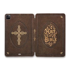 May include: A brown leather-bound book with a gold cross and the words "HOLY BIBLE" embossed on the cover.