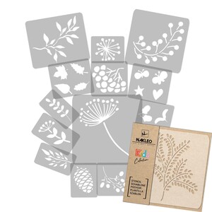 May include: A set of 12 grey stencils featuring various floral and nature-themed designs, including leaves, branches, berries, butterflies, stars, and a heart. The stencils are arranged in a stack, with the top stencil showing a branch with leaves. The stencils are made of a durable material and are perfect for crafting and decorating.