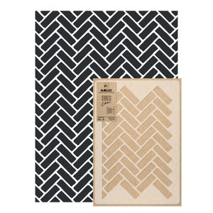 May include: A stencil for creating a herringbone pattern. The stencil is made of brown cardboard and has a white herringbone pattern cut out. The stencil is part of the Nakleo Seamless Collection.