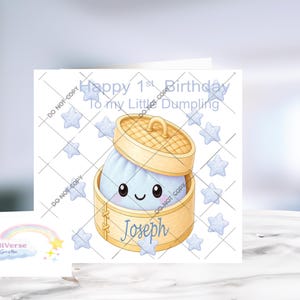 May include: A square greeting card featuring a cartoon dumpling with a smiling face inside a bamboo steamer basket. The text reads Happy 1st Birthday To my Little Dumpling and Joseph. Light blue stars surround the central illustration on a white background.
