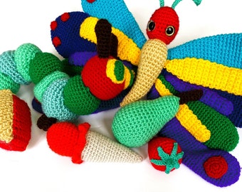 May include: A set of crocheted stuffed toys, including a caterpillar, a butterfly, a pear, a strawberry, and an ice cream cone. The toys are made in various colors, including green, red, yellow, blue, and purple.
