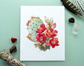 Peut inclure: Peinture à l'aquarelle d'un cactus de figue de Barbarie avec des fleurs rouges. Le cactus est vert et a une surface texturée. Les fleurs sont d'un rouge vif et ont des centres jaunes.