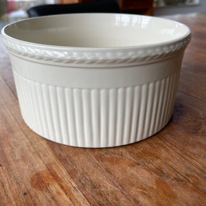 May include: White ceramic baking dish with a fluted design and a rope-like trim around the top.